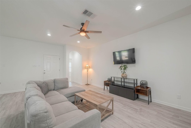 living room featuring ceiling fan and light hardwood / wood-style floors