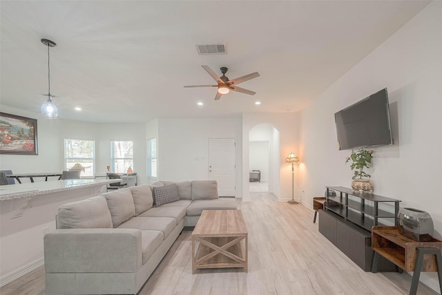 living room featuring light wood-type flooring and ceiling fan