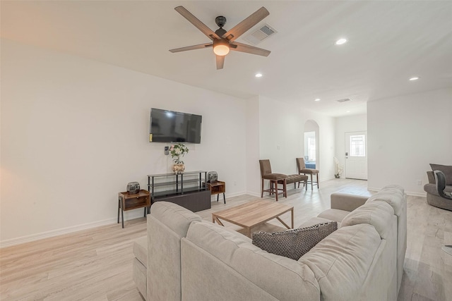 living room featuring ceiling fan and light hardwood / wood-style floors