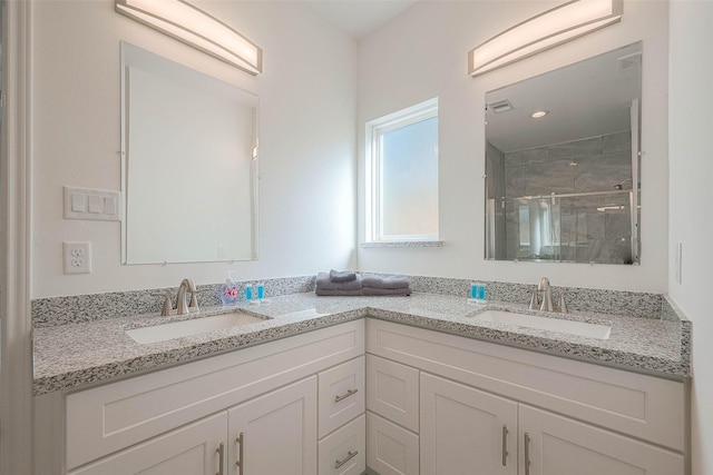 bathroom with vanity and a shower with door