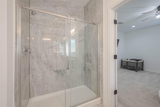 bathroom featuring an enclosed shower and ceiling fan