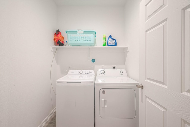 laundry room featuring washer and clothes dryer and hardwood / wood-style flooring