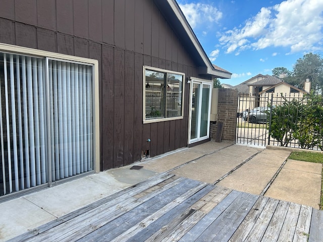 wooden deck featuring a patio and fence