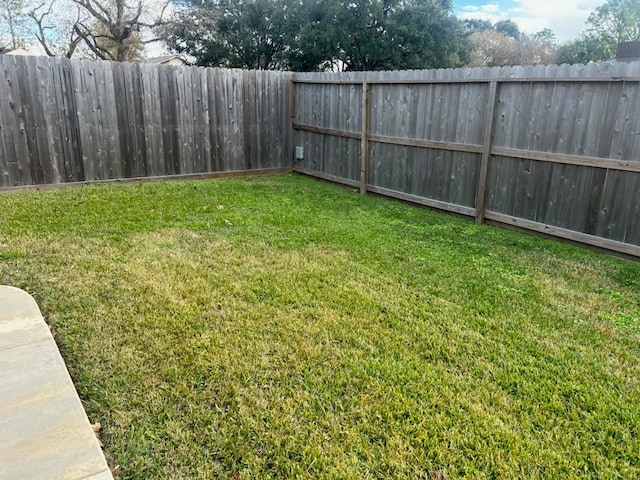 view of yard with a fenced backyard