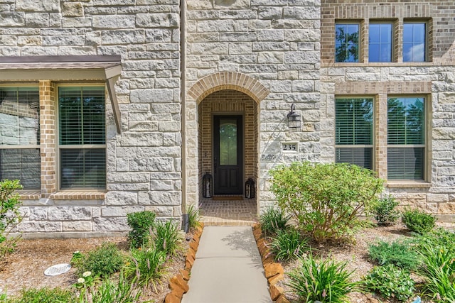 view of exterior entry featuring stone siding