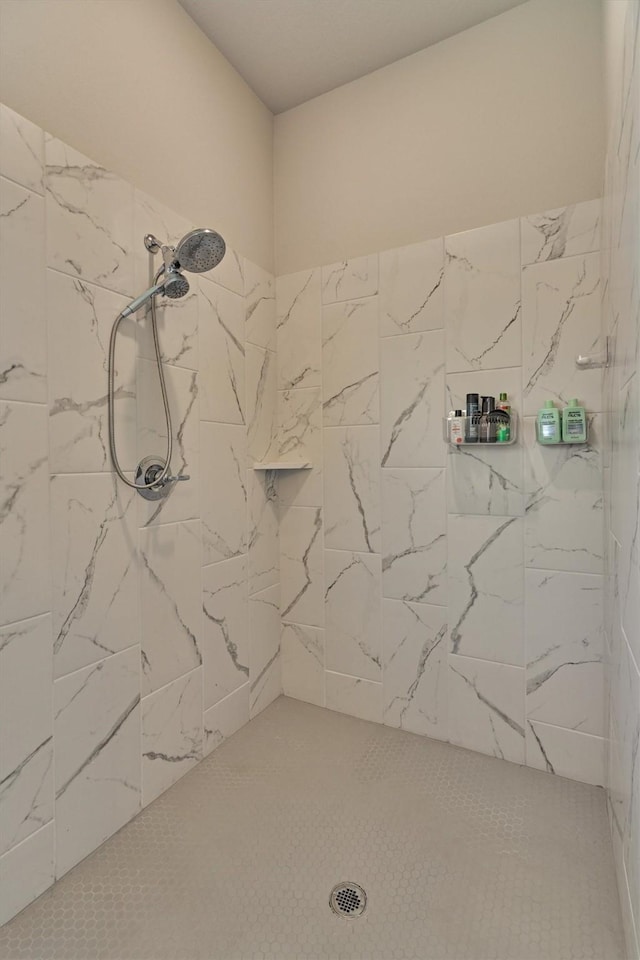 bathroom with tiled shower