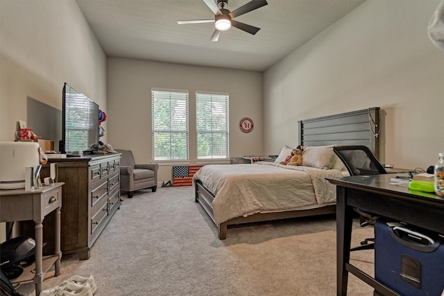 bedroom with a ceiling fan and light colored carpet