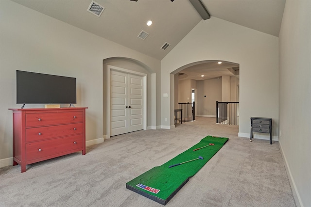 workout area with light colored carpet and high vaulted ceiling