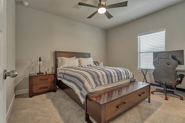 bedroom with ceiling fan and light colored carpet