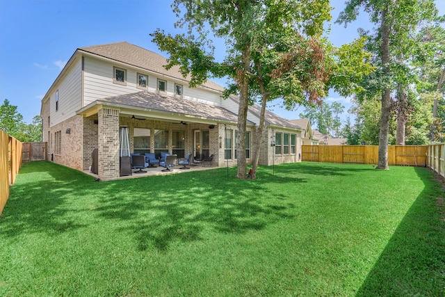 back of house featuring a patio area, brick siding, a fenced backyard, and a lawn