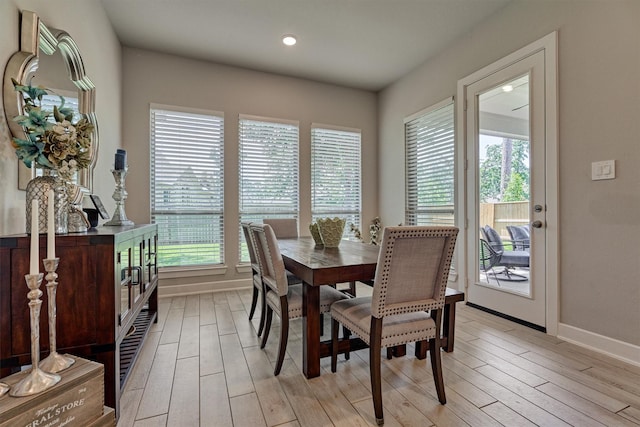 dining space with a wealth of natural light and light hardwood / wood-style floors