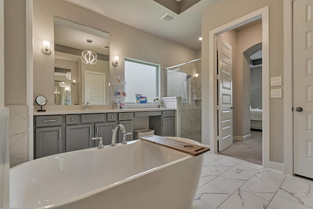 full bath featuring a freestanding tub, visible vents, baseboards, marble finish floor, and a marble finish shower