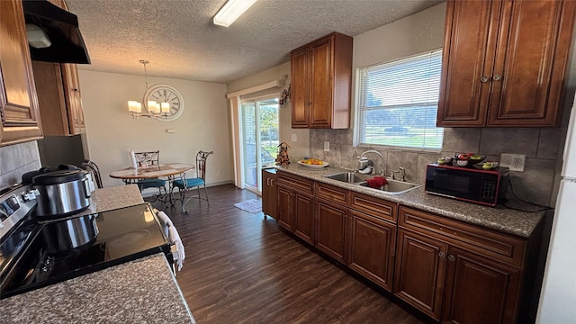 kitchen featuring backsplash, electric stove, dark hardwood / wood-style flooring, pendant lighting, and sink