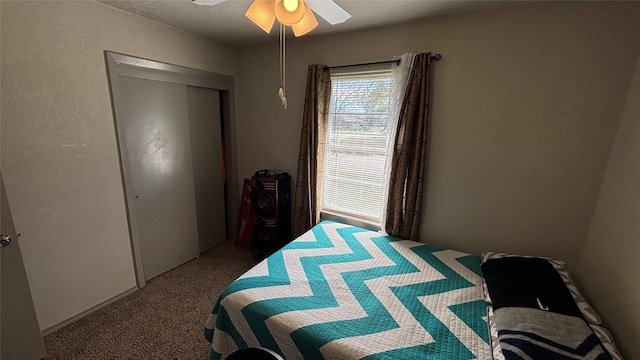 bedroom with ceiling fan, carpet, and a closet