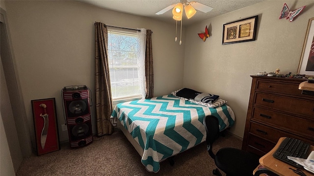 carpeted bedroom featuring a textured ceiling and ceiling fan