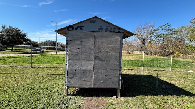 view of outbuilding featuring a lawn