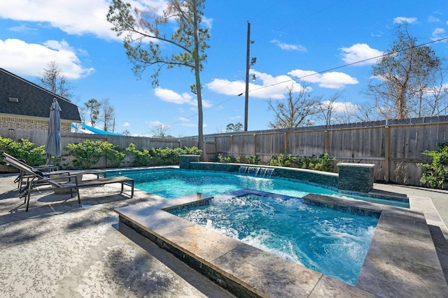 view of swimming pool with an in ground hot tub, pool water feature, and a patio