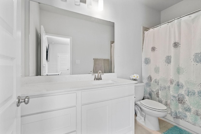 bathroom with toilet, tile patterned flooring, and vanity