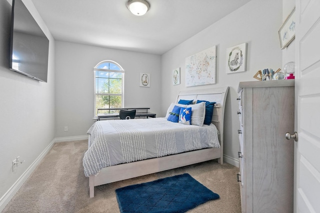 bedroom featuring light carpet