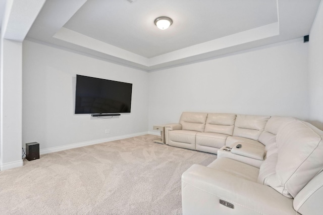 living room with carpet and a tray ceiling