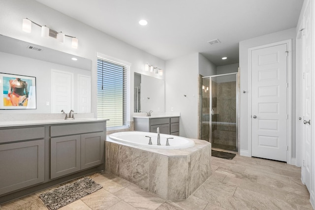 bathroom featuring separate shower and tub and vanity