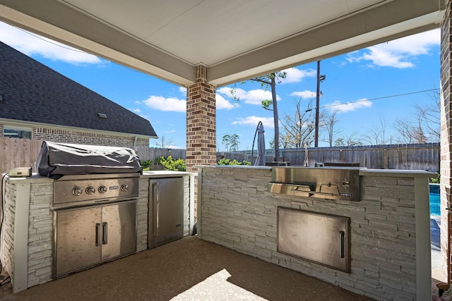 view of patio with an outdoor kitchen and area for grilling