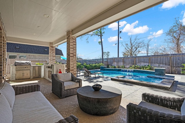 view of patio / terrace featuring a fenced in pool, an outdoor kitchen, and a grill