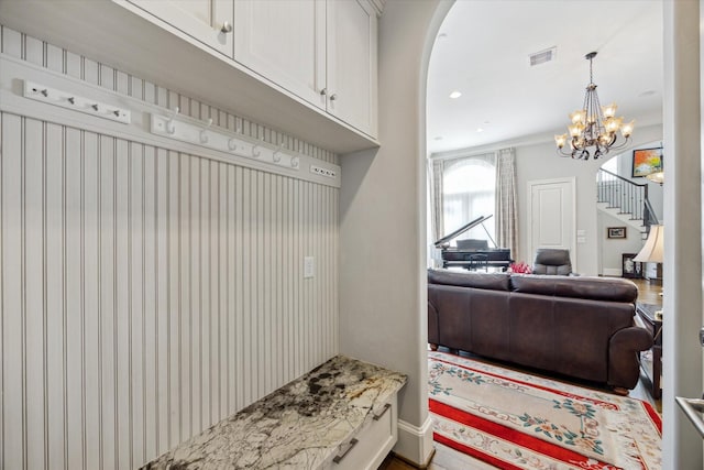 mudroom featuring an inviting chandelier