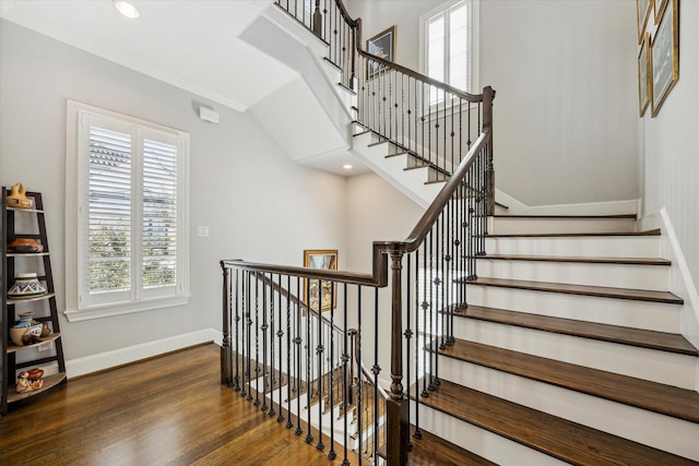 stairway with crown molding and hardwood / wood-style floors