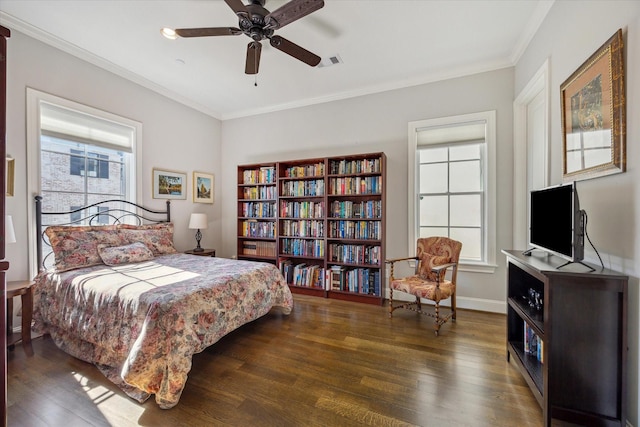 bedroom featuring multiple windows, wood finished floors, and crown molding