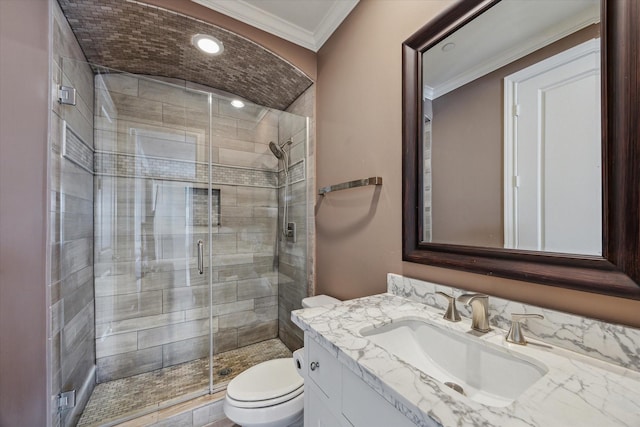 bathroom with toilet, ornamental molding, a shower with shower door, and vanity