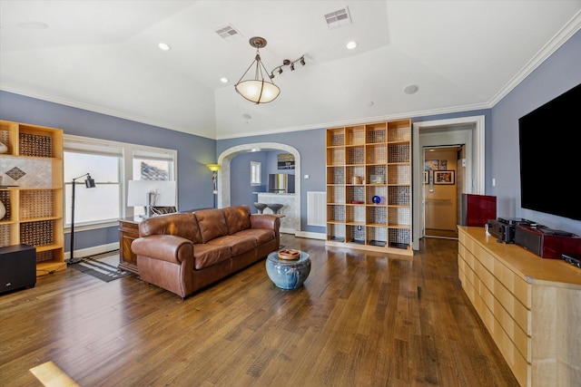 living area featuring arched walkways, wood finished floors, lofted ceiling, and visible vents