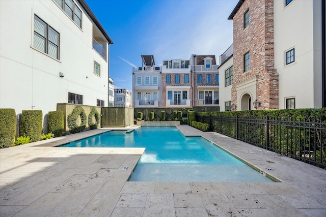 pool featuring a patio area and fence