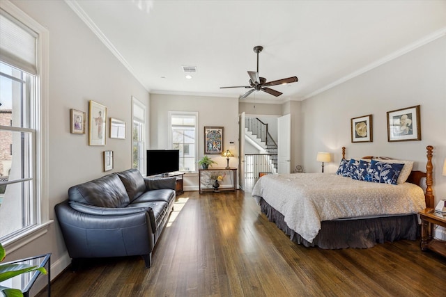 bedroom featuring visible vents, crown molding, and hardwood / wood-style floors