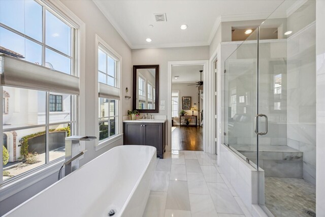 bathroom with tile patterned flooring, vanity, ornamental molding, and shower with separate bathtub