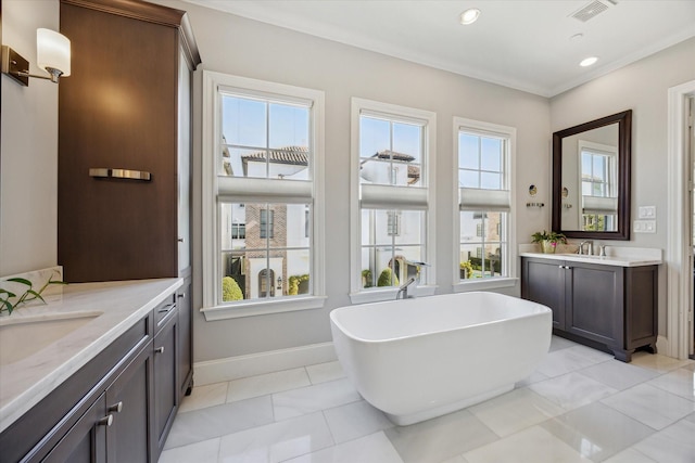 full bathroom with recessed lighting, a sink, two vanities, visible vents, and a soaking tub