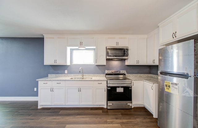 kitchen with white cabinets, dark hardwood / wood-style flooring, sink, and stainless steel appliances