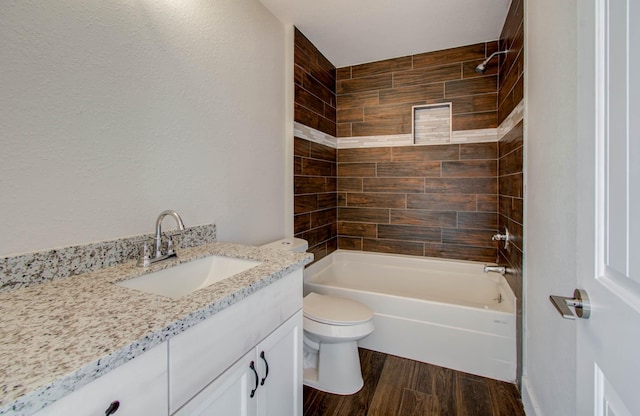 full bathroom with tiled shower / bath combo, vanity, and toilet