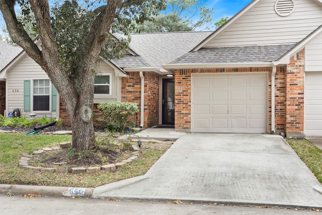 single story home with driveway, a garage, brick siding, and roof with shingles