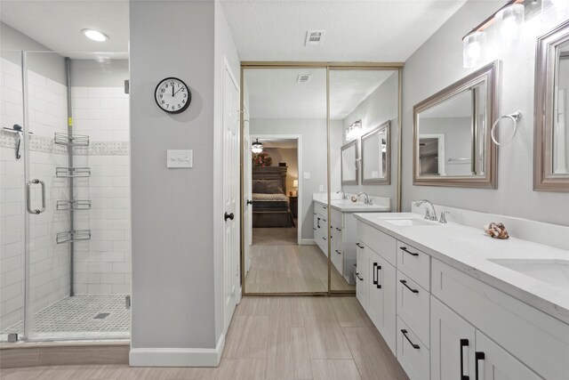 654 W Country Grove Cir, Pearland, TX 77584 - full bathroom featuring ensuite bathroom, a shower stall, double vanity, and baseboards