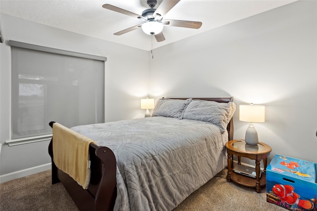 carpeted bedroom with baseboards and a ceiling fan