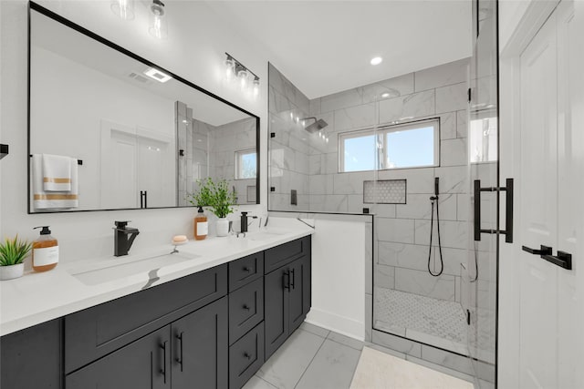 bathroom with a shower with shower door and vanity