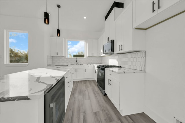 kitchen with white cabinets, range with gas stovetop, wine cooler, hanging light fixtures, and light stone counters