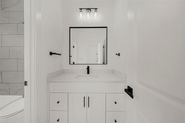 bathroom featuring toilet and vanity