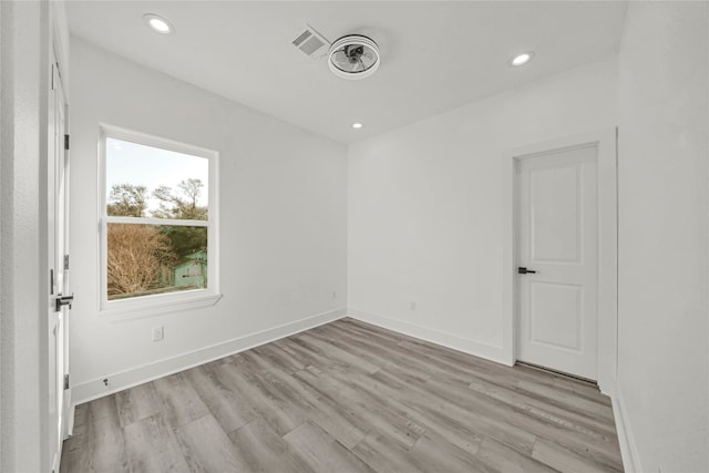 empty room with light hardwood / wood-style flooring