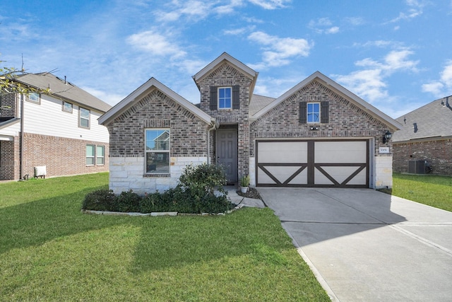 view of front of home with a front yard, cooling unit, driveway, stone siding, and brick siding