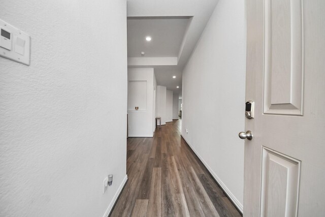 corridor with dark wood-type flooring