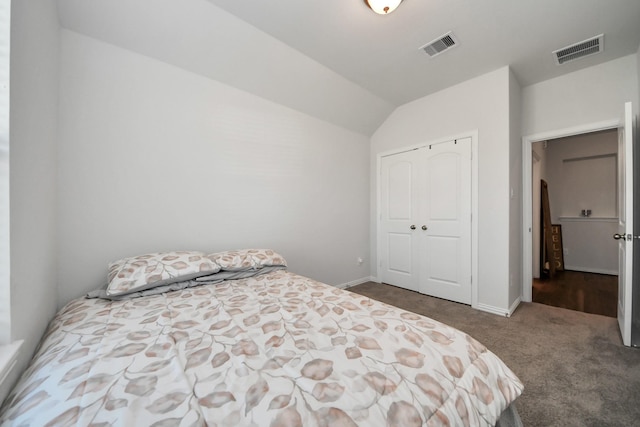 bedroom with a closet, carpet, baseboards, visible vents, and lofted ceiling
