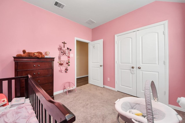 carpeted bedroom featuring visible vents, a closet, and baseboards