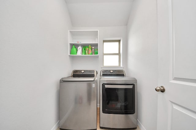 clothes washing area with washer and clothes dryer